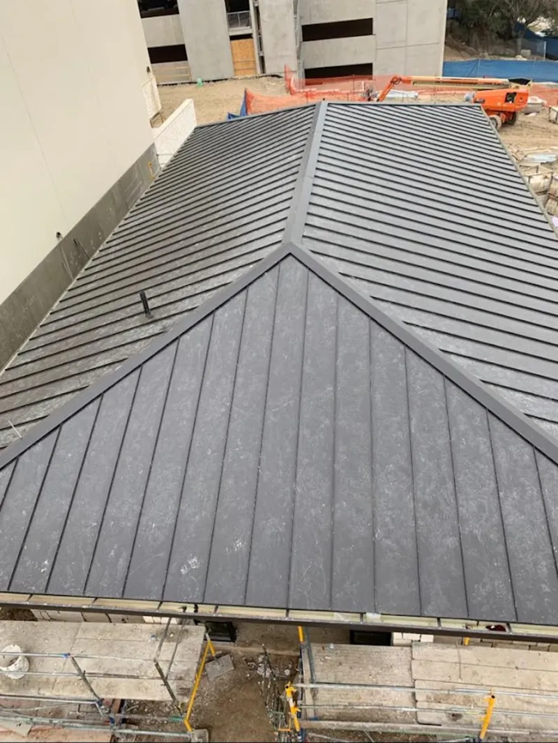 Commercial metal roof construction with crane equipment in Chadron