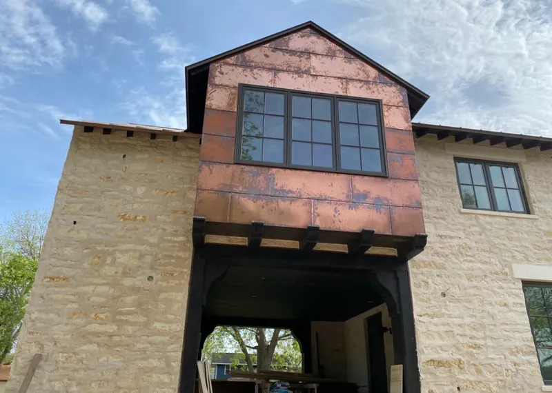 Copper metal panel facade on a stone building for Metal Roof Coating in Chadron